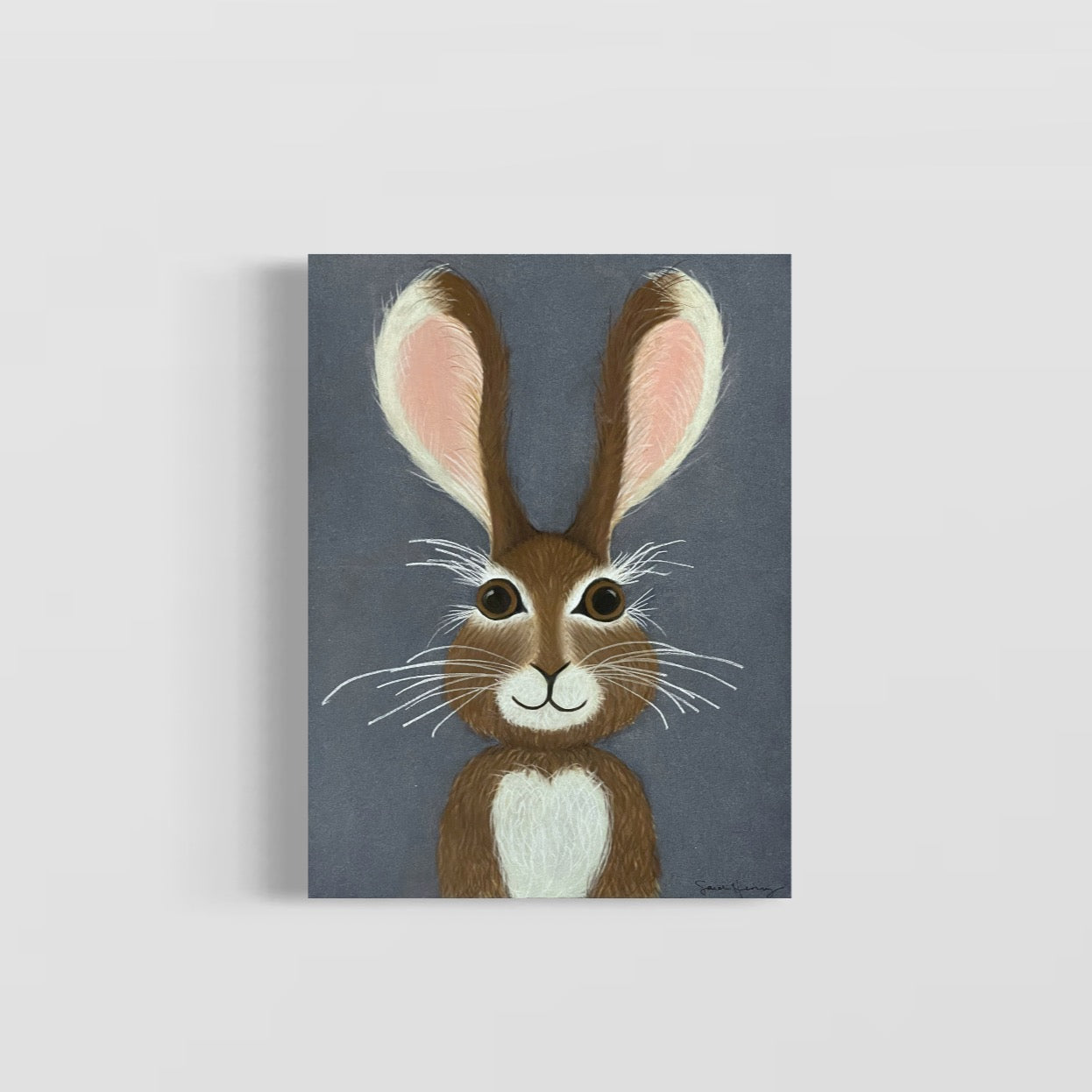 Charming original art of a hare with brown hair against a blue background, showcasing playful features and a warm smile