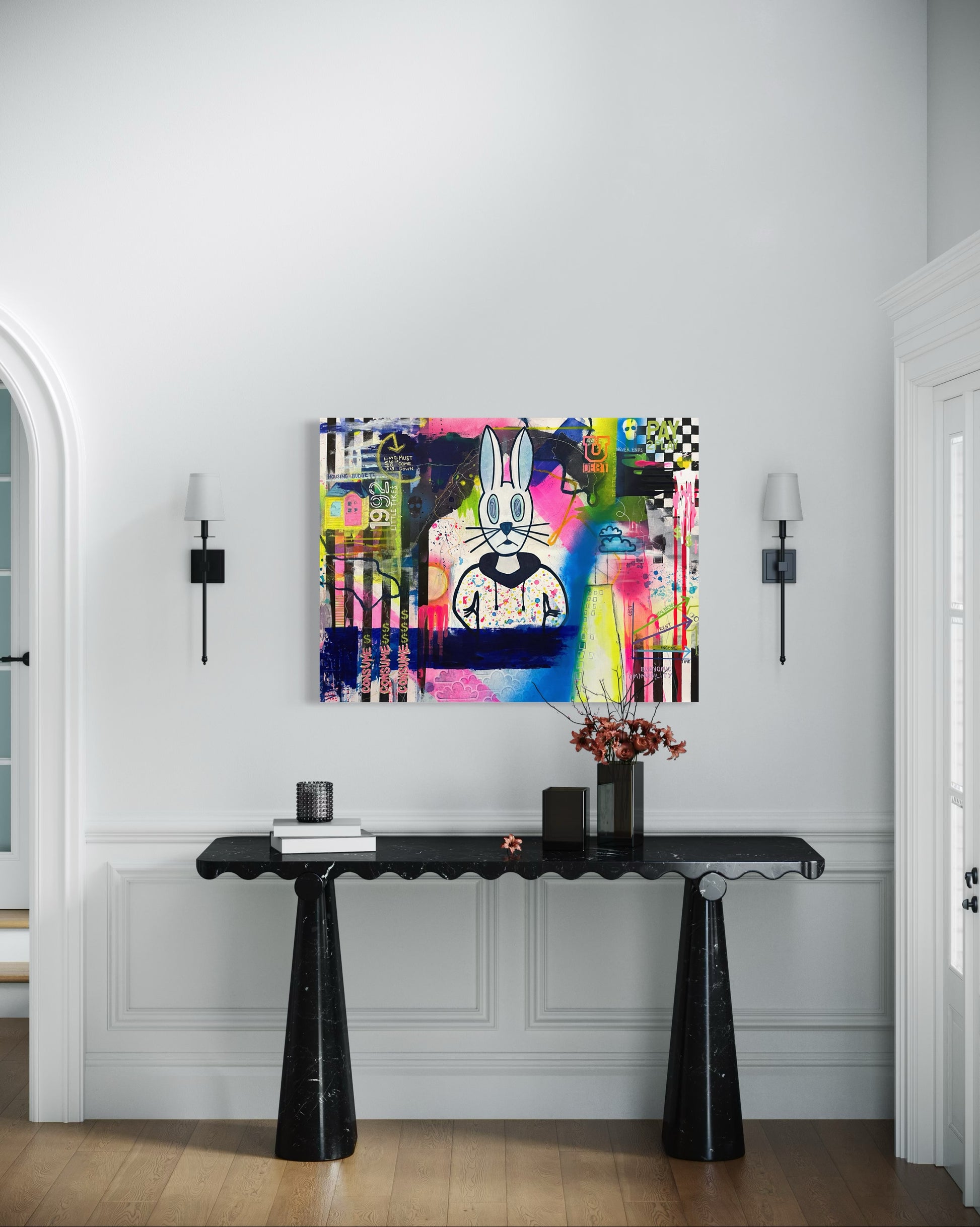 An original 30"x40" painting by Chicago Artist Sarah Henry in abstract expressionist style with graffiti and street art elements hangs on a white wall. The art showcases the struggle of economic mobility for the working, middle, and lower classes with visual commentary on the housing crises, student loan debt, global warming, economic volatility, increasing cost of living, and flat wage growth. It sits above a black entryway table with a modern aesthetic.