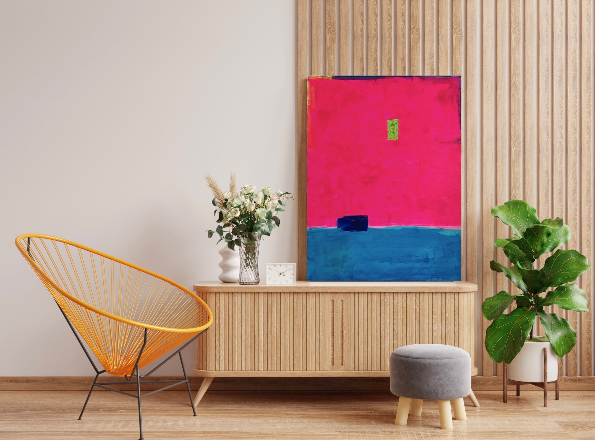 Oversized large abstract art features a bold composition of vibrant fuchsia pink occupying the upper portion and deep blue in the lower section. A small, ultramarine blue rectangular shape sits near the dividing line, while a tiny neon green rectangle is positioned slightly above the center. Along the top, the fluorescent pink stops short of the edge of the canvas, showing a small border of blue, purple, and neon yellow. The 36"x48" original painting hangs on a white wall in a contemporary entryway.