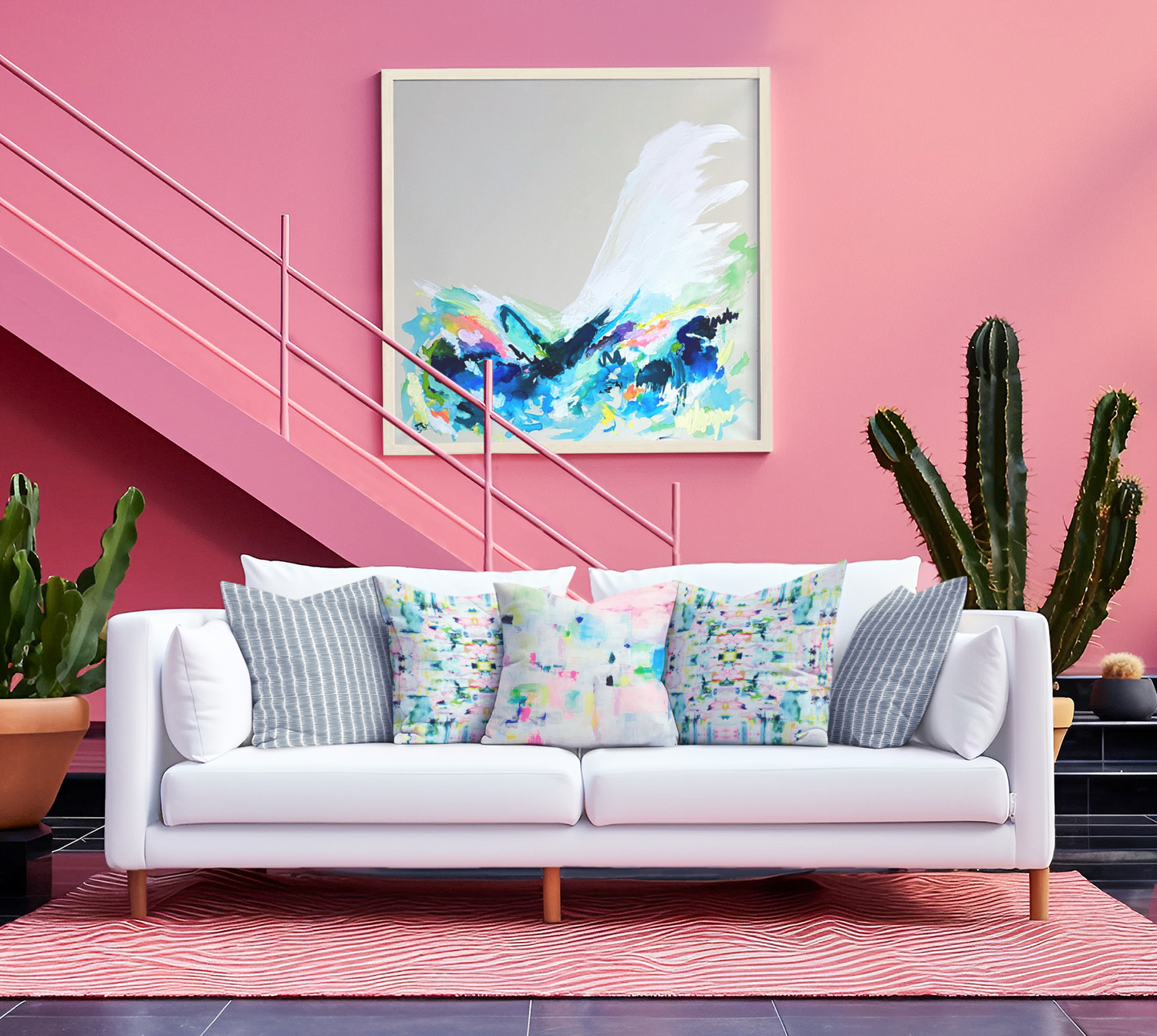 A contemporary living room with abstract wall art, a pink accent wall, a white sofa in an eclectic room.