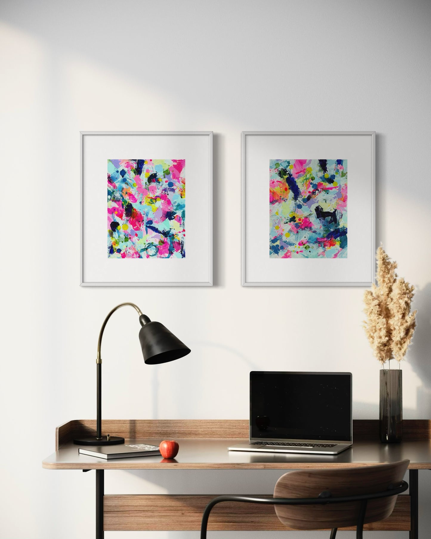 A modern gallery collection of abstract paintings featuring vibrant splashes of color, including pink, blue, yellow, green, purple and white. Each canvas is filled with expressive, energetic brushstrokes and layered paint splatters, creating a dynamic and contemporary composition. The affordable wall decor is arranged side by side on a white office wall.