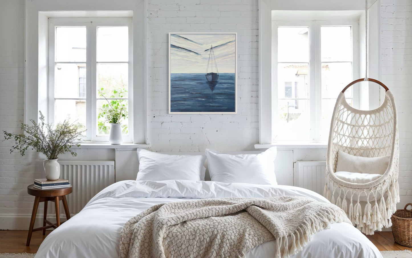 An affordable serene ocean painting of a solitary sailboat floating on calm, deep blue waters. The boat is slightly off center in the composition, with its reflection subtly visible on the water’s surface. The sky above is painted with soft, muted tones of pale blue, white and navy, with expressive brushstrokes forming abstract cloud patterns. The horizon line is faint, blending seamlessly with the sky and sea, creating a tranquil and minimalist atmosphere. The wall decor hangs on a white wall.