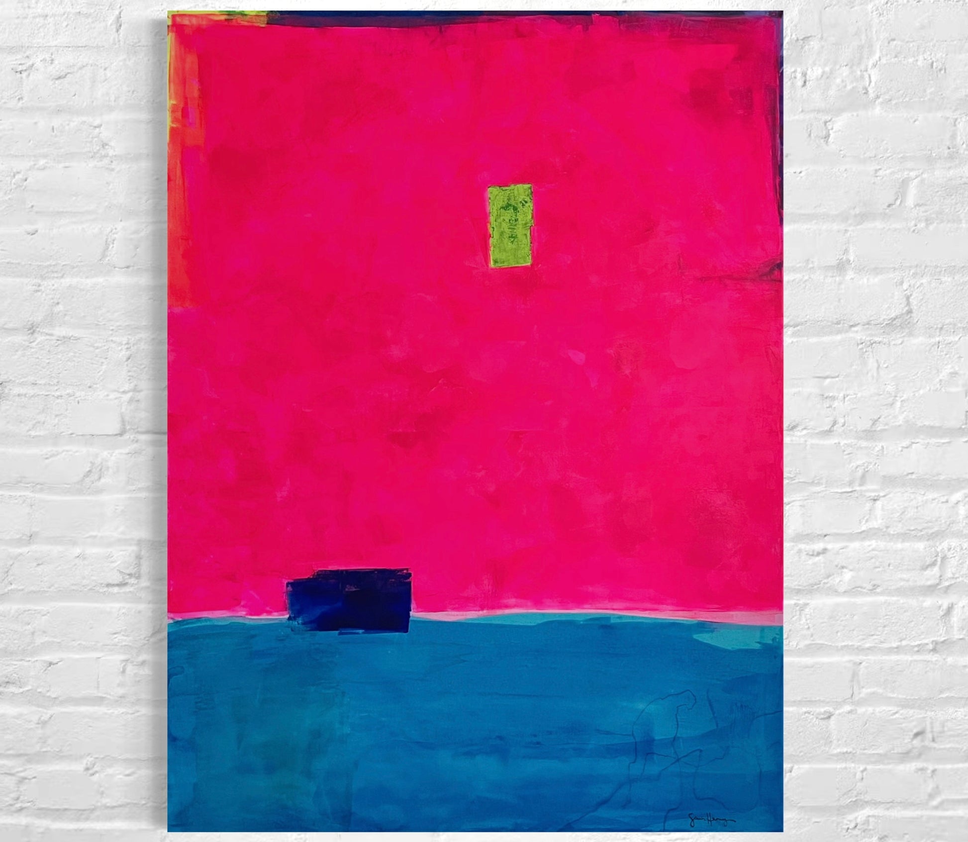Oversized large abstract art features a bold composition of vibrant fuchsia pink occupying the upper portion and deep blue in the lower section. A small, ultramarine blue rectangular shape sits near the dividing line, while a tiny neon green rectangle is positioned slightly above the center. Along the top, the fluorescent pink stops short of the edge of the canvas, showing a small border of blue, purple, and neon yellow. The 36"x48" original painting hangs on a white brick wall.