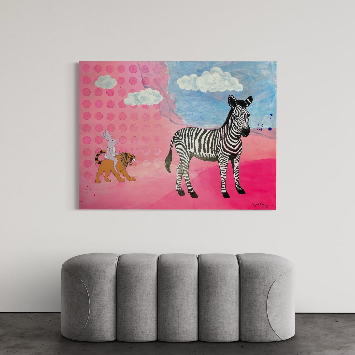 Original abstract pink and blue art with a zebra and tiger, displayed above a gray sofa.