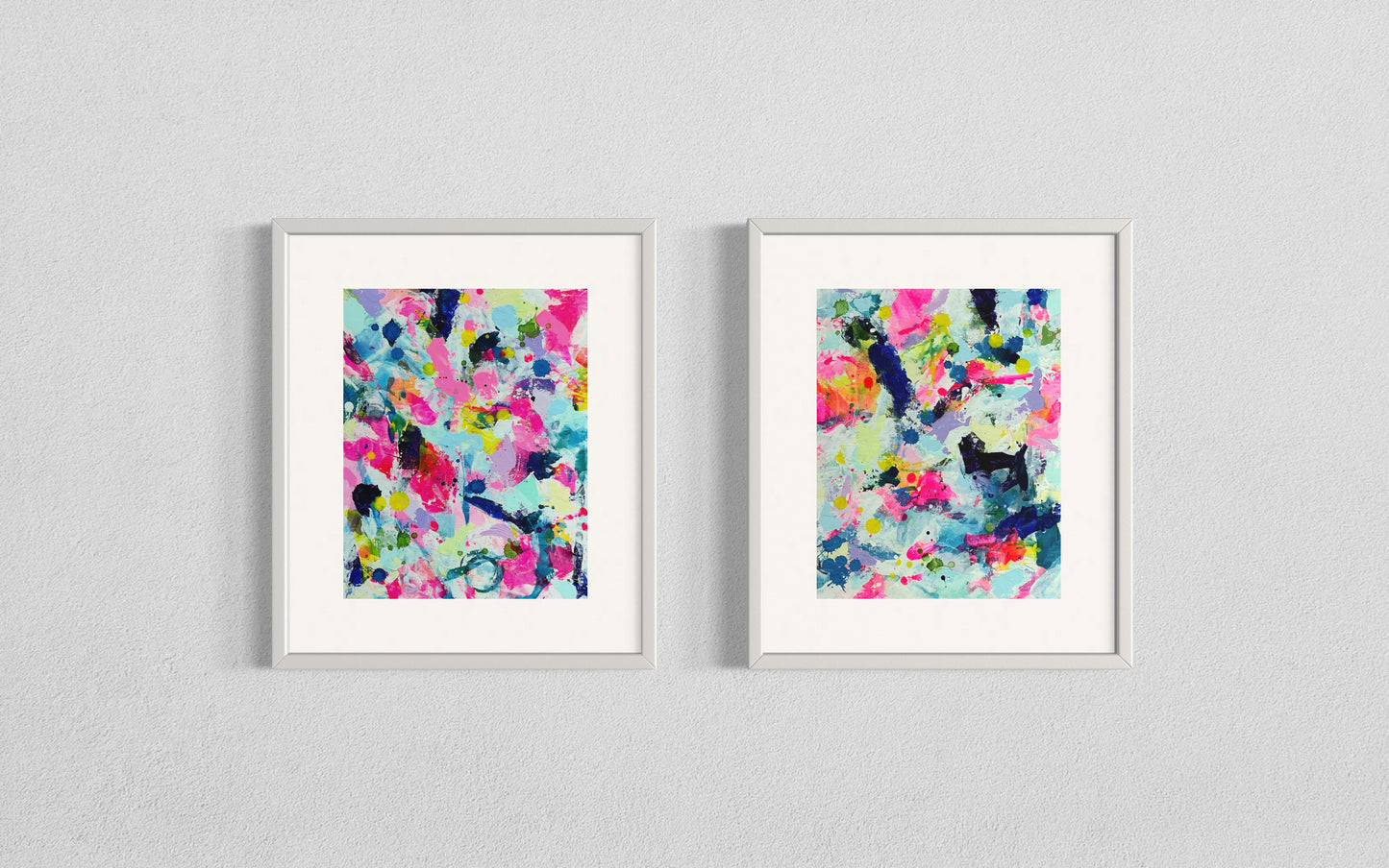 A modern gallery collection of abstract paintings featuring vibrant splashes of color, including pink, blue, yellow, green, purple and white. Each canvas is filled with expressive, energetic brushstrokes and layered paint splatters, creating a dynamic and contemporary composition. The affordable wall decor is arranged side by side on a white wall, forming a cohesive yet varied visual experience.