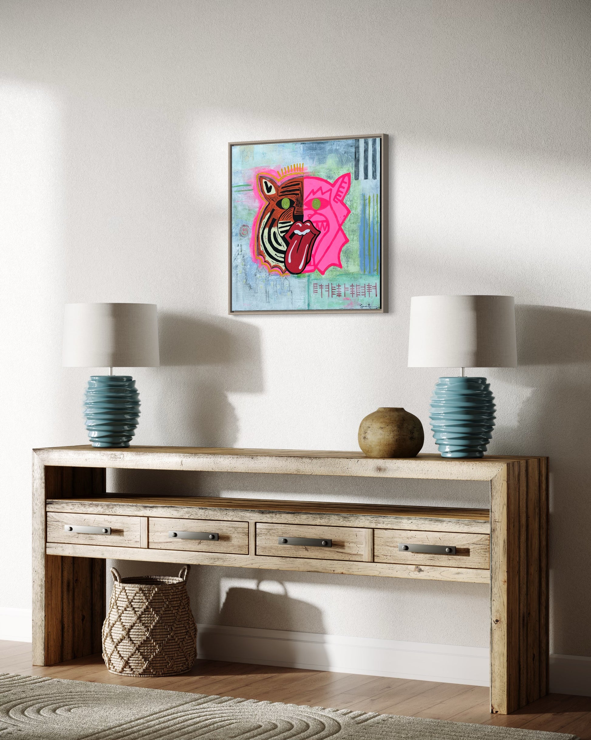 A 20 inch by 20 inch affordable abstract expressionist original painting by Sarah Henry Art featuring a dual faced tiger, one side orange the other pink, with a honey comb, black and white stripes, the Chicago skyline, a smiley face, and ogham writing stating not silenced hangs on a white wall in a living room.