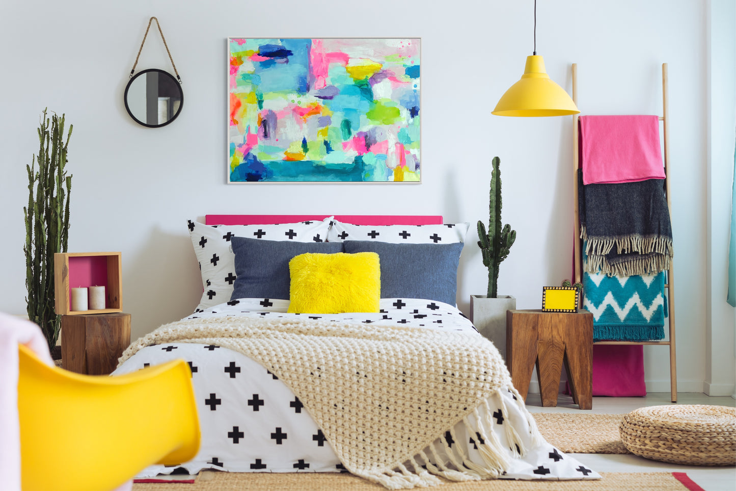 The Dolly Original Abstract Painting by Sarah Henry in a colorful maximalist bedroom with black and white bedding, a yellow ceiling lamp, pink headboard, blue pillows, pink blankets, and a yellow chair.
