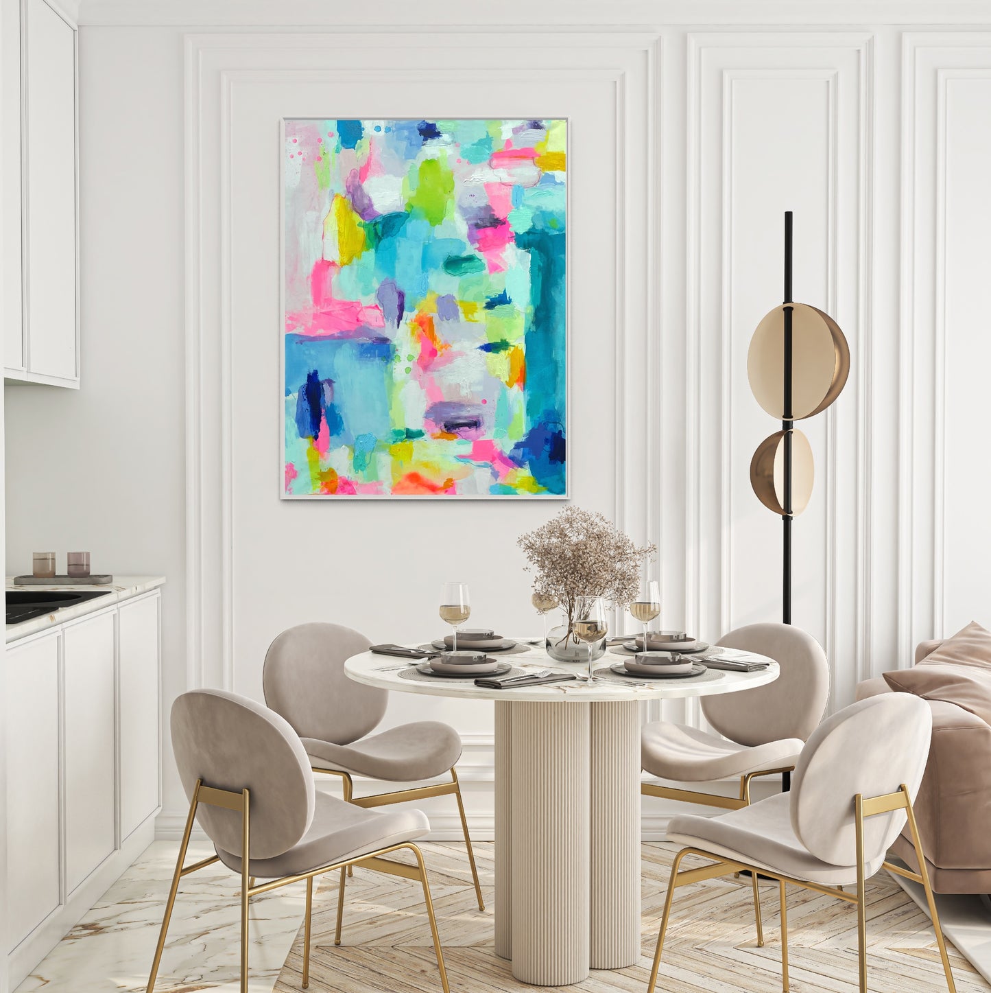 The Dolly Original Abstract Painting by Sarah Henry as part of the Happy Art Collection, shown on a white wall with molding in a dining room with a monochromatic white color scheme, a white round scalloped base table, and four white and gold modern dining chairs.