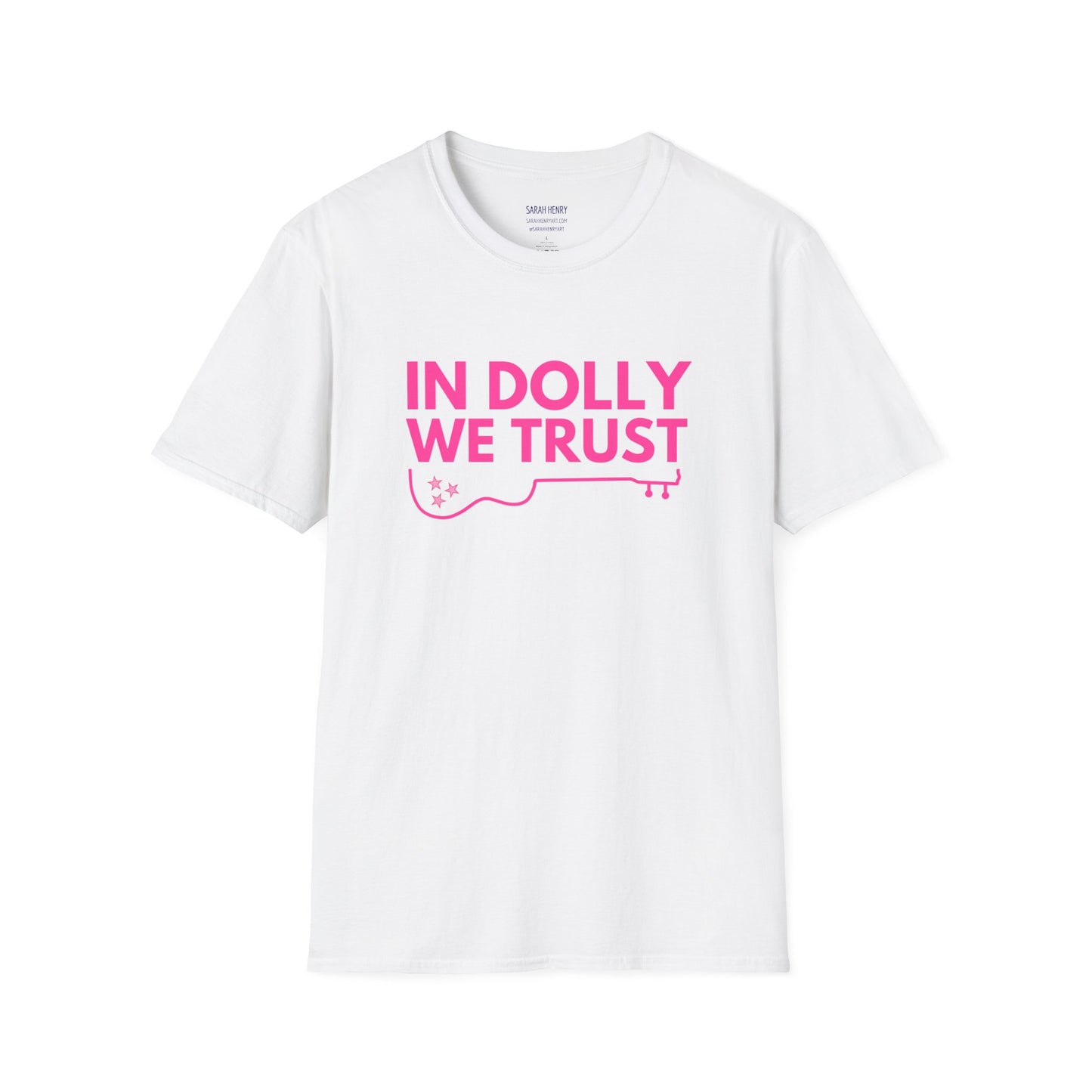 A white dolly parton shirt with pink letters saying In Dolly We Trust