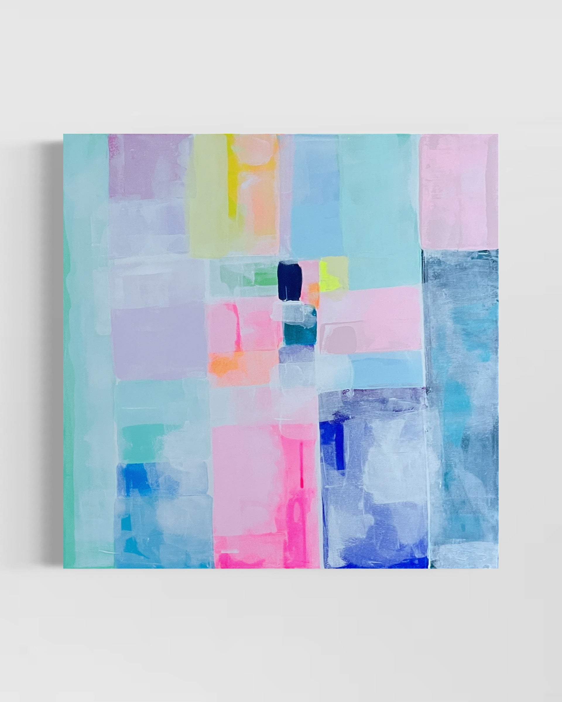A contemporary abstract painting featuring geometric shapes in pastel colors mounted on a wall.