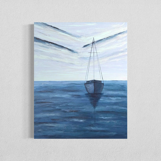 An affordable serene ocean painting of a solitary sailboat floating on calm, deep blue waters. The boat is slightly off center in the composition, with its reflection subtly visible on the water’s surface. The sky above is painted with soft, muted tones of pale blue, white and navy, with expressive brushstrokes forming abstract cloud patterns. The horizon line is faint, blending seamlessly with the sky and sea, creating a tranquil and minimalist atmosphere. The wall decor hangs on a white wall. 