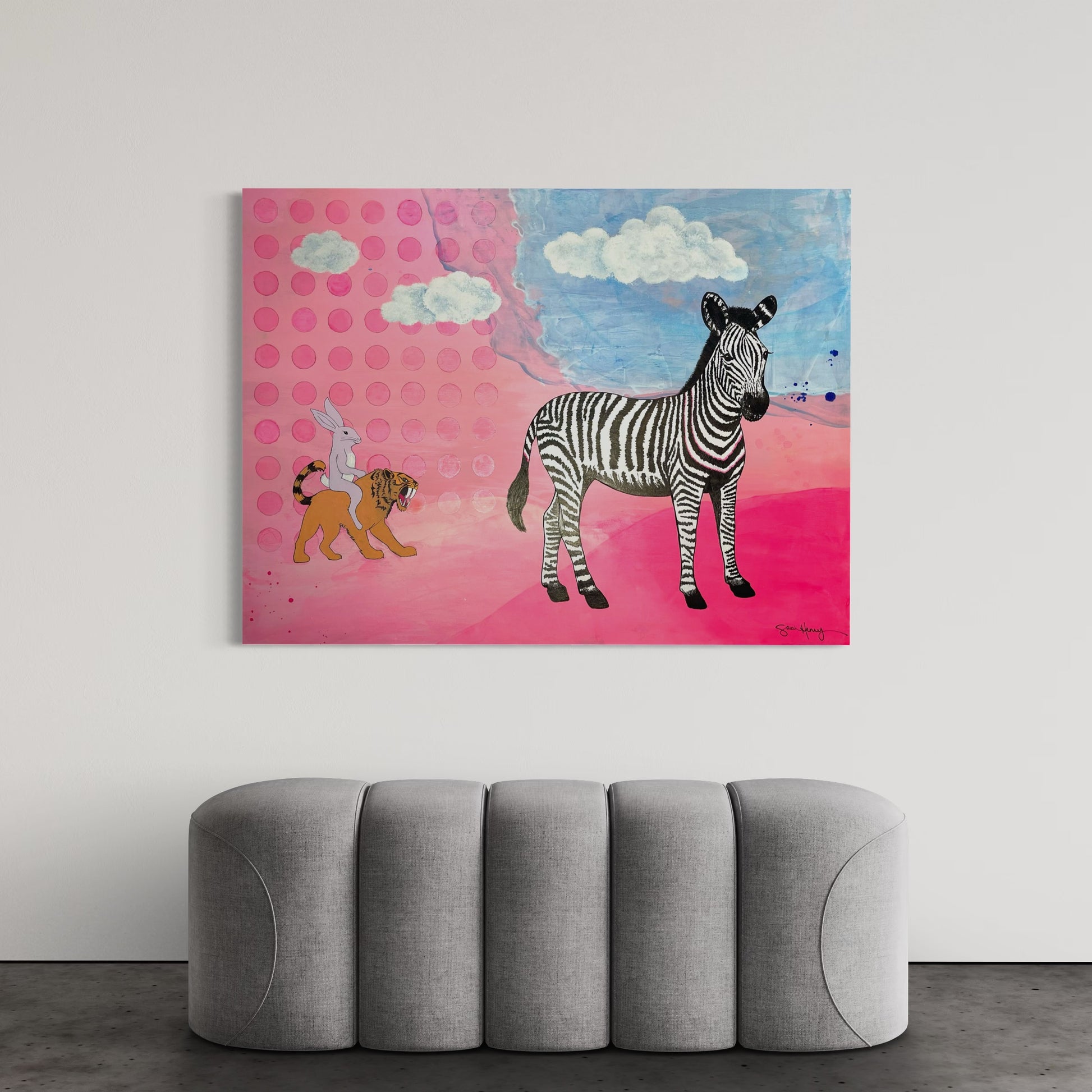 Original abstract pink and blue art with a zebra and tiger, displayed above a gray sofa.