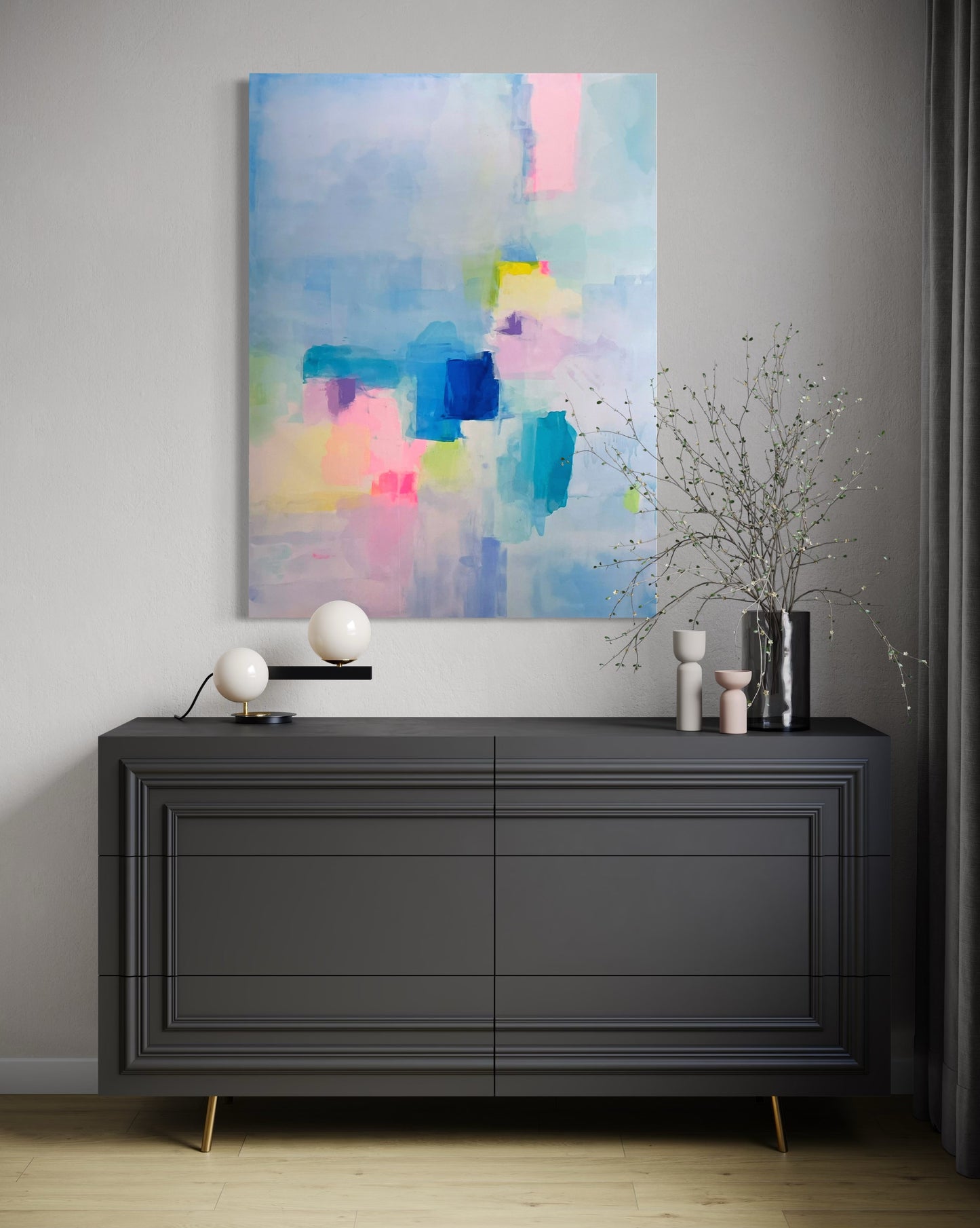 Modern interior with a black dresser and contemporary abstract painting on a gray wall