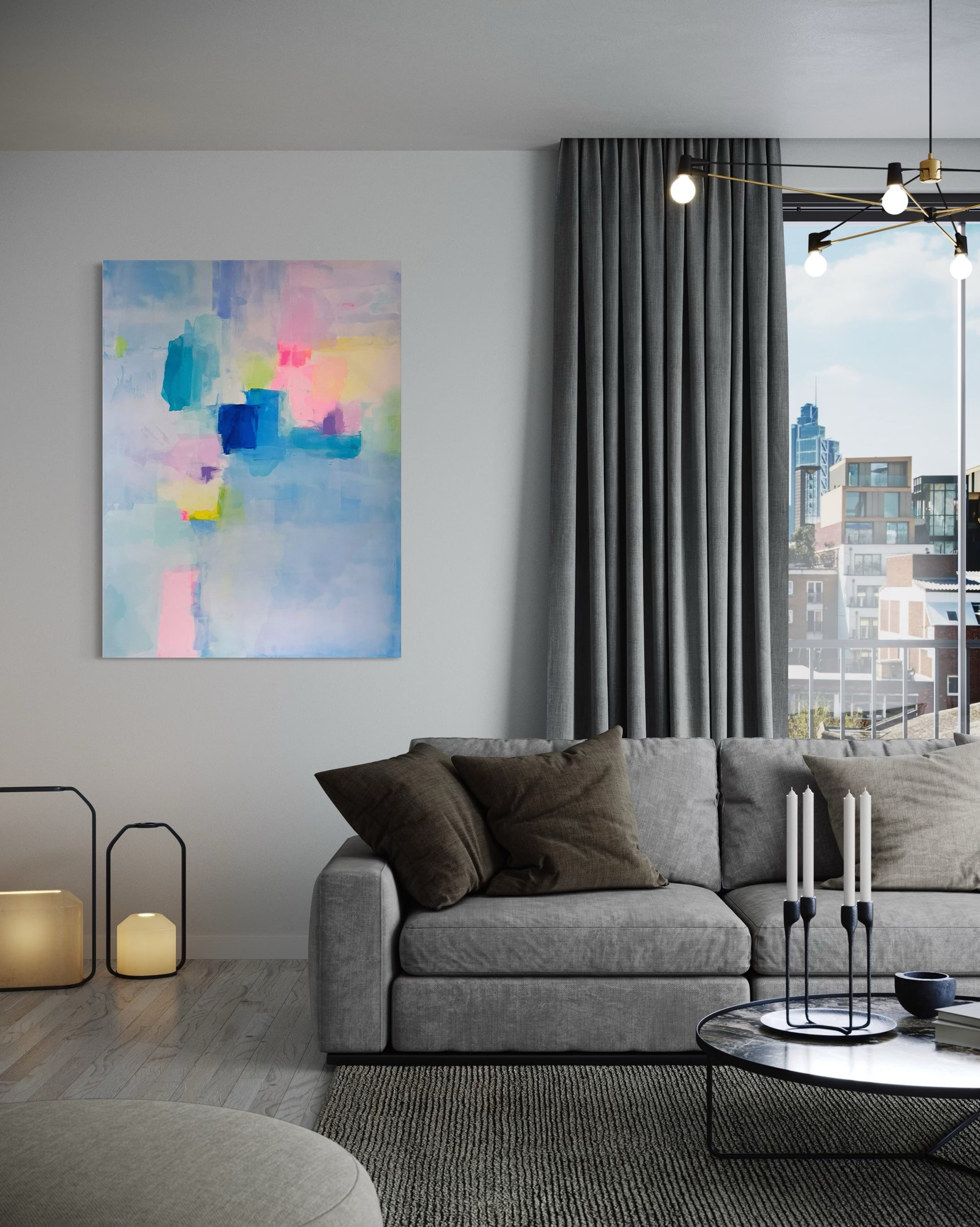 Modern living room with a gray sofa, abstract painting, and cityscape view.