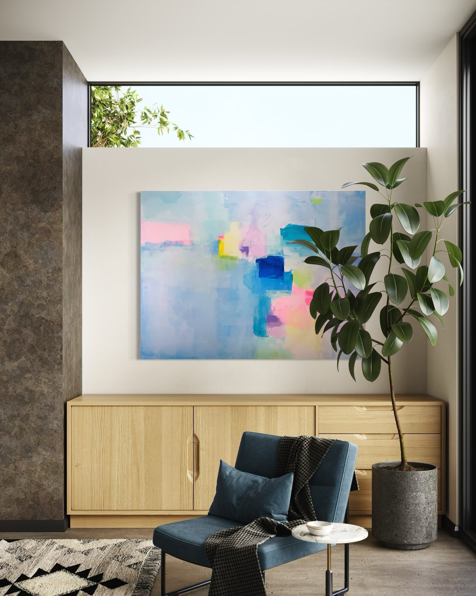 Modern living room with abstract art, blue chair, and potted plant.