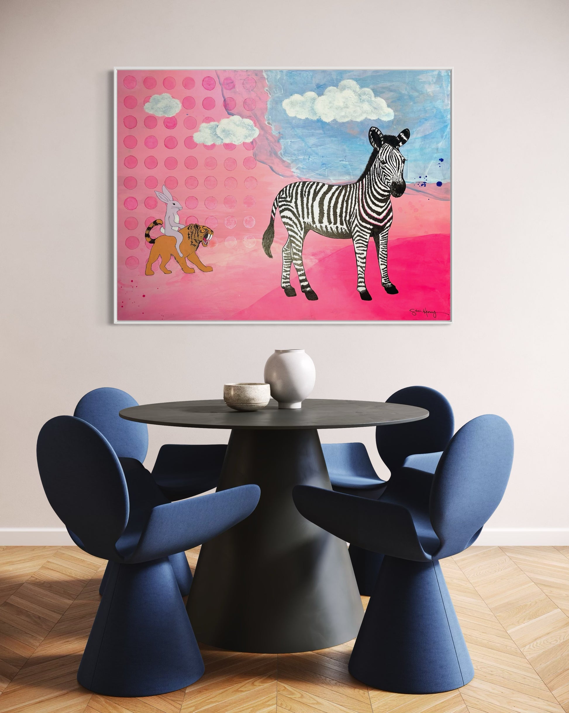 Dining room with a modern table and blue chairs with an expressionism expressionist painting on the wall.