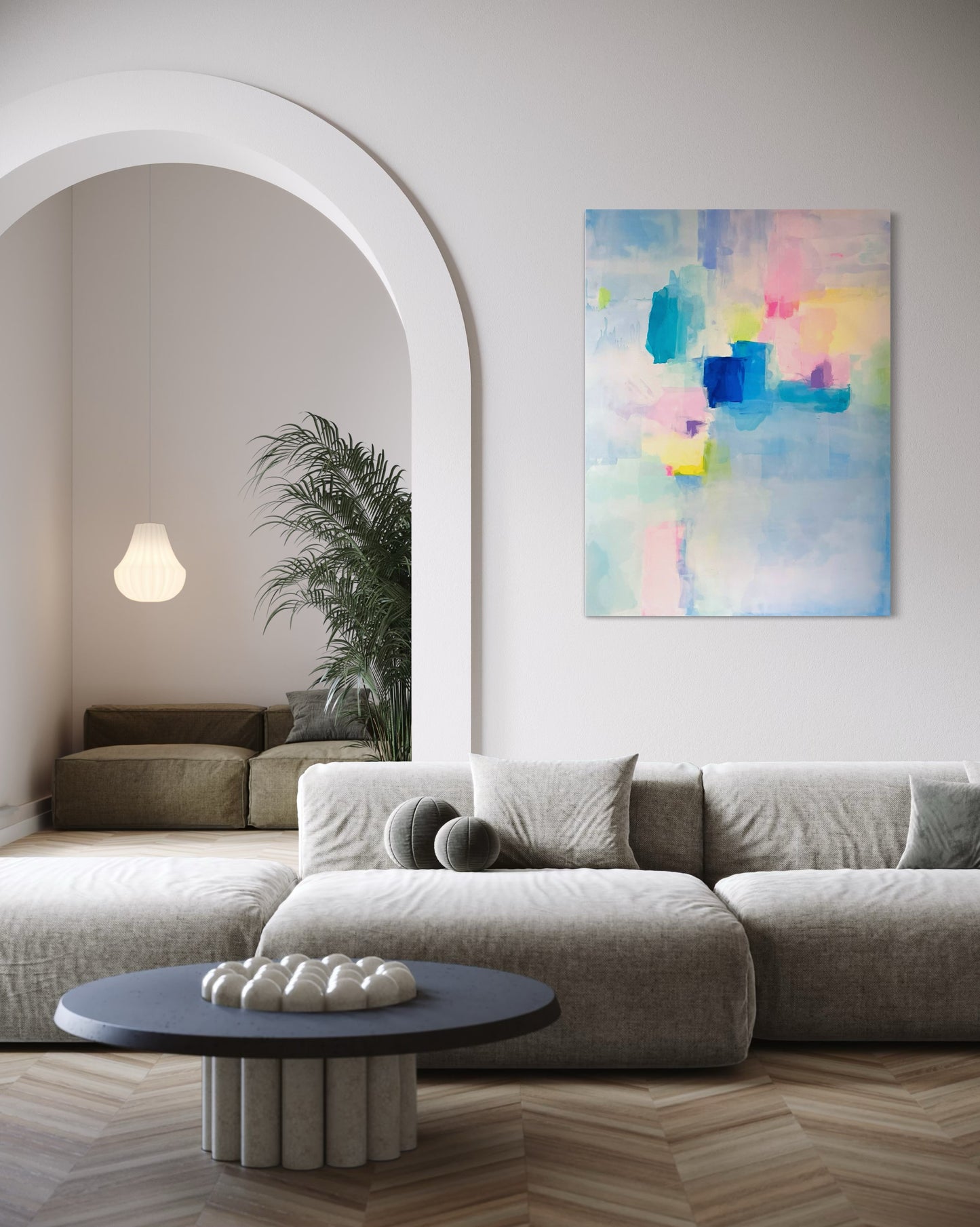 Modern living room with a colorful abstract painting on the wall featuring soft pastel tones of pink, blue, teal, and yellow.