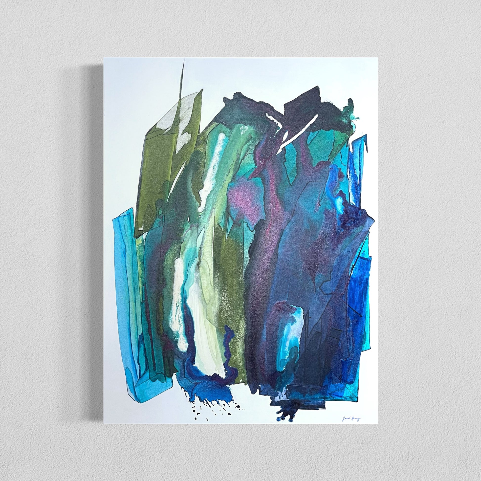 Abstract painting of vivid blue and green acrylic ink flows with layered translucent forms on a gray wall.