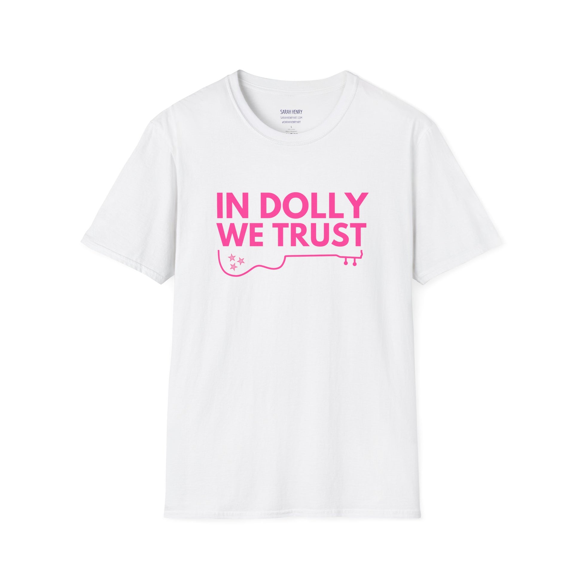A white dolly parton shirt with pink letters saying In Dolly We Trust