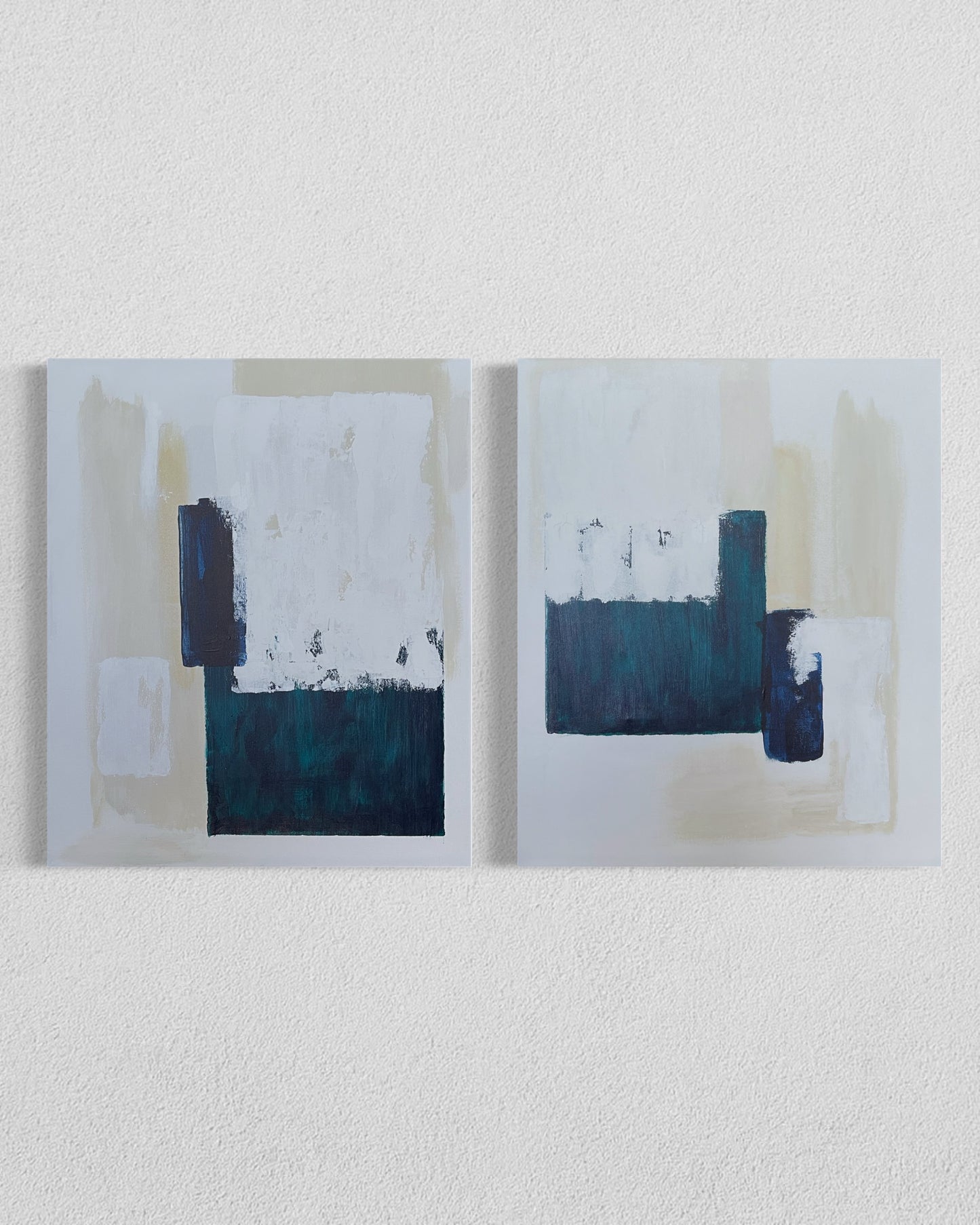 Two-panel abstract painting in cream, navy, and green with textured geometric shapes
