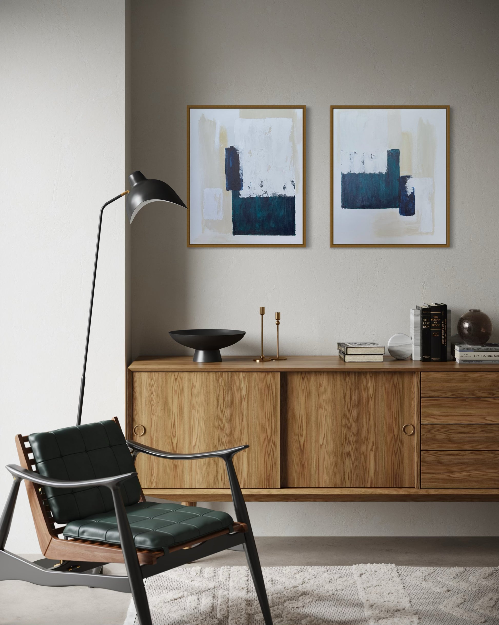 Modern living room with wooden cabinet, abstract diptych art in turquoise and white, and a chair.