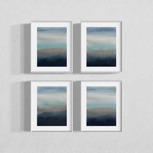 Four framed watercolor paintings with soft gradients of blue, gray, and teal tones.